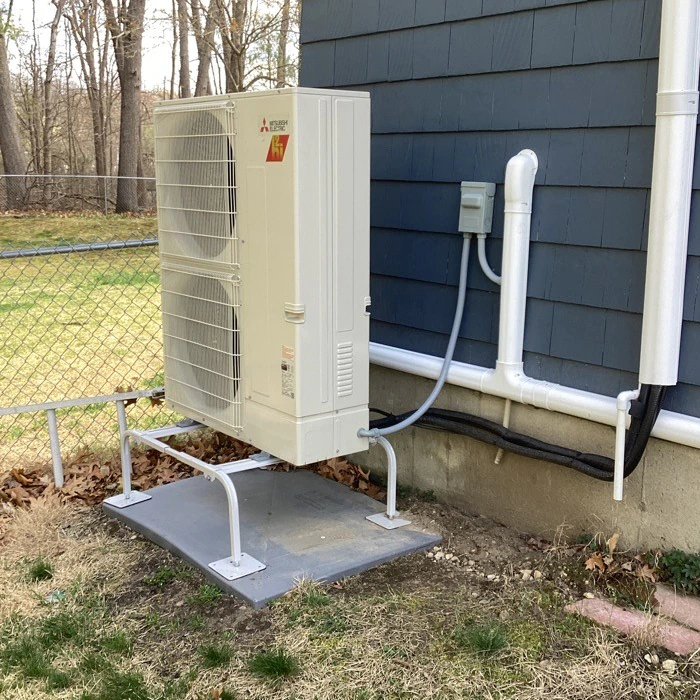 Mitsubishi condenser HVAC installation outside a house by South Shore HVAC Services in Abington, MA