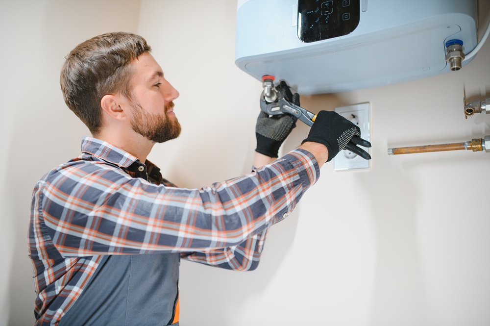 Professional engineer installing a natural gas boiler at home, he is checking the pipes