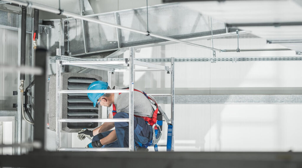 HVAC Worker Checking on Commercial Warehouse Heater (1)